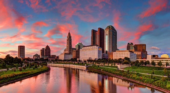 View of Columbus, Ohio cityscape and waterway at sunset